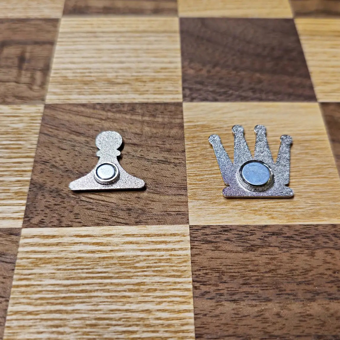 The back of an enameled magnetic chess piece, showing the magnets.