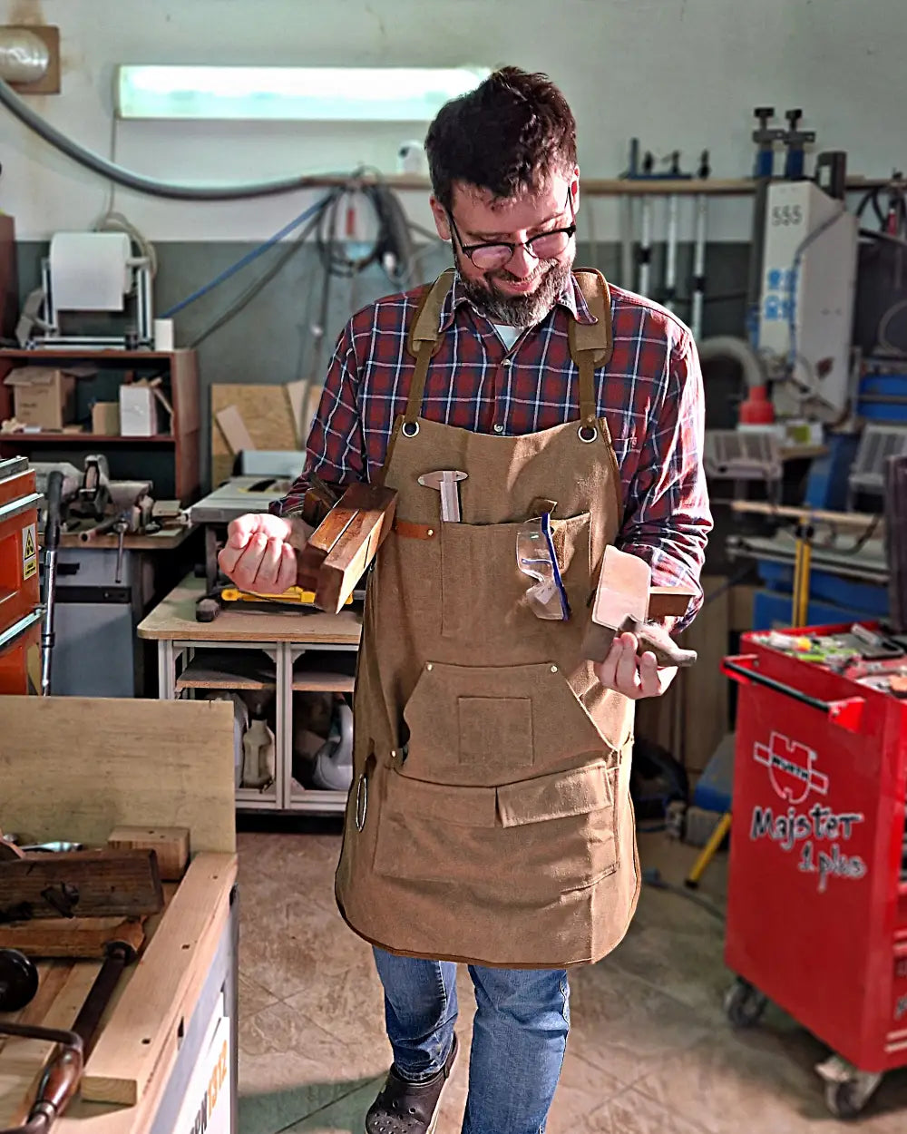 Michał Fudalej in the carpentry workshop with hand tools for woodworking.