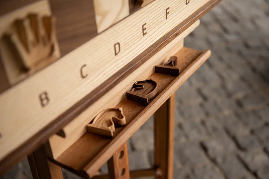 Fine art photograph of handcrafted wooden chess pieces arranged on a ChessboArt board, minimalist composition