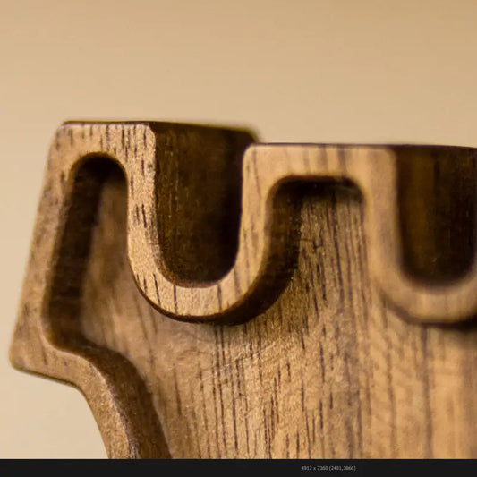 Close-up detail of a wooden chess rook highlighting craftsmanship and material texture