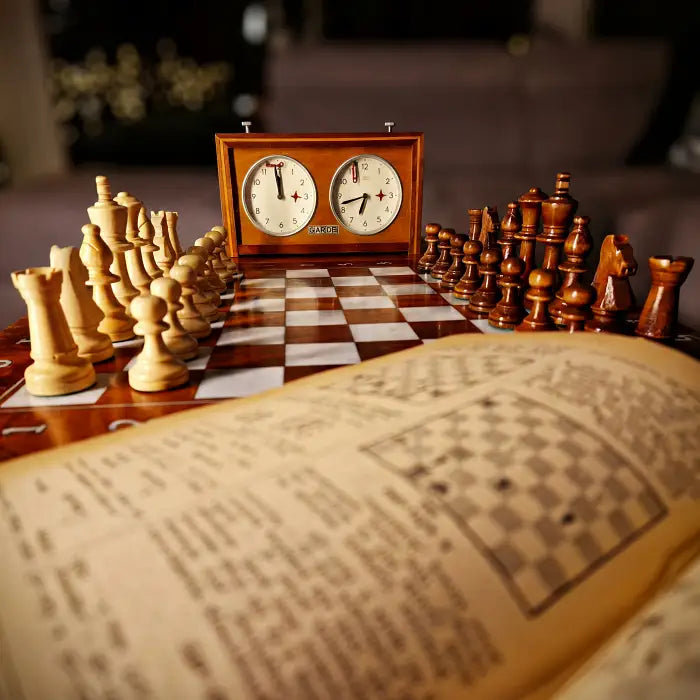 Luxury wooden chess coffee table V2 with analog chess clocks and an open book.