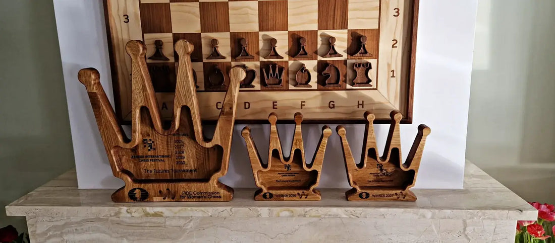 Custom wooden chess trophies displayed at Prague Chess Festival, handcrafted queen-shaped awards in natural wood