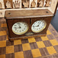 Angled view of the pre-1930 HAU chess clock, highlighting the deep patina of the oak wood case and the vintage metal push buttons.