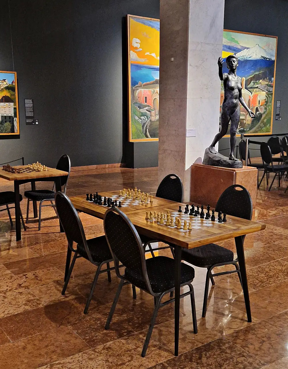 Large handcrafted wooden chess tables by ChessboArt displayed among sculptures and paintings at the Hungarian National Gallery during the Global Chess Festival 2025