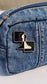 Pawn emblem pin fastened to a denim zip pouch, casual streetwear detail
