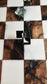 Overhead close-up of a chess enamel pin on a black, white and green resin chessboard