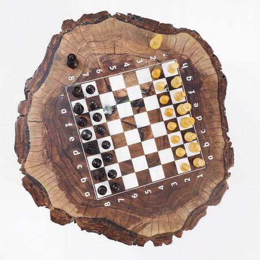 An angled, low-perspective photograph showcasing the incredible depth and wood grain texture of the ChessboArt walnut stump chess table with its embedded epoxy board and pieces.