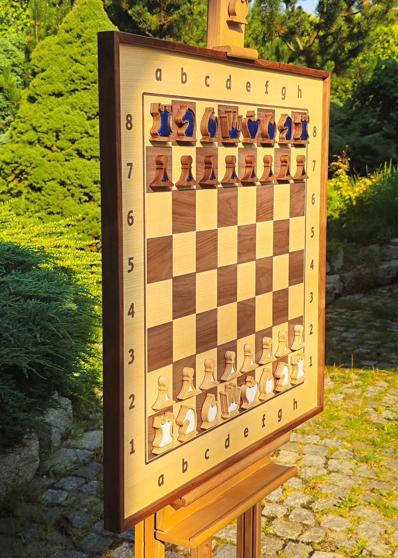 Wall chess board with pearl blue and white magnetic epoxy resin inlays, angled outdoor view