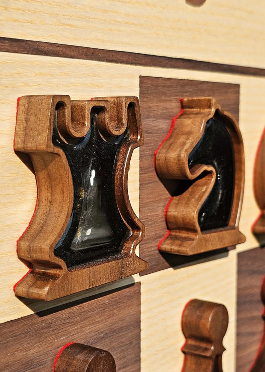 Close-up of rook and knight chess pieces with pearl black magnetic epoxy resin inlays