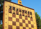 Wall chess board with pearl black magnetic epoxy resin inlays across the full row of black pieces