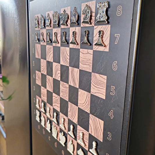 Close-up of the Ebony Grain magnetic chessboard on a stainless steel refrigerator door