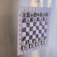 ChessboPIN magnetic chess set with Epoxy Ivory board mounted on a refrigerator, full starting position