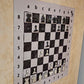 Close-up of enamel chess pieces on the hand-painted Ivory Canvas magnetic wall chessboard