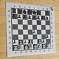 ChessboPIN magnetic chess set with Ivory Grain wood-grain board, full set in a mid-game position