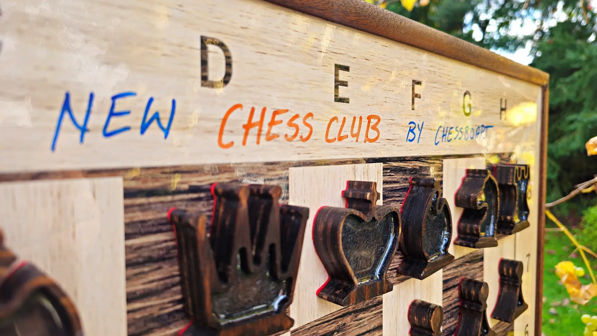 Dry-erase marker writing on the ChessClub board surface above magnetic chess pieces