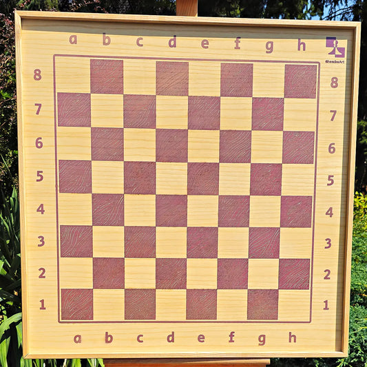 Front view of the empty ChessboINK wall-mounted chessboard made of ash wood, highlighting the pink painted squares, coordinate notation, and natural wood grain.