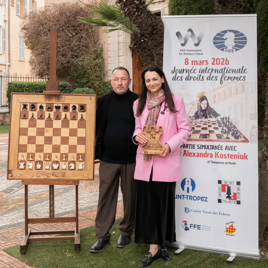 Grandmaster Alexandra Kosteniuk and Andrzej Kordowina-Tkacz posing with a large chessboard in Saint-Tropez