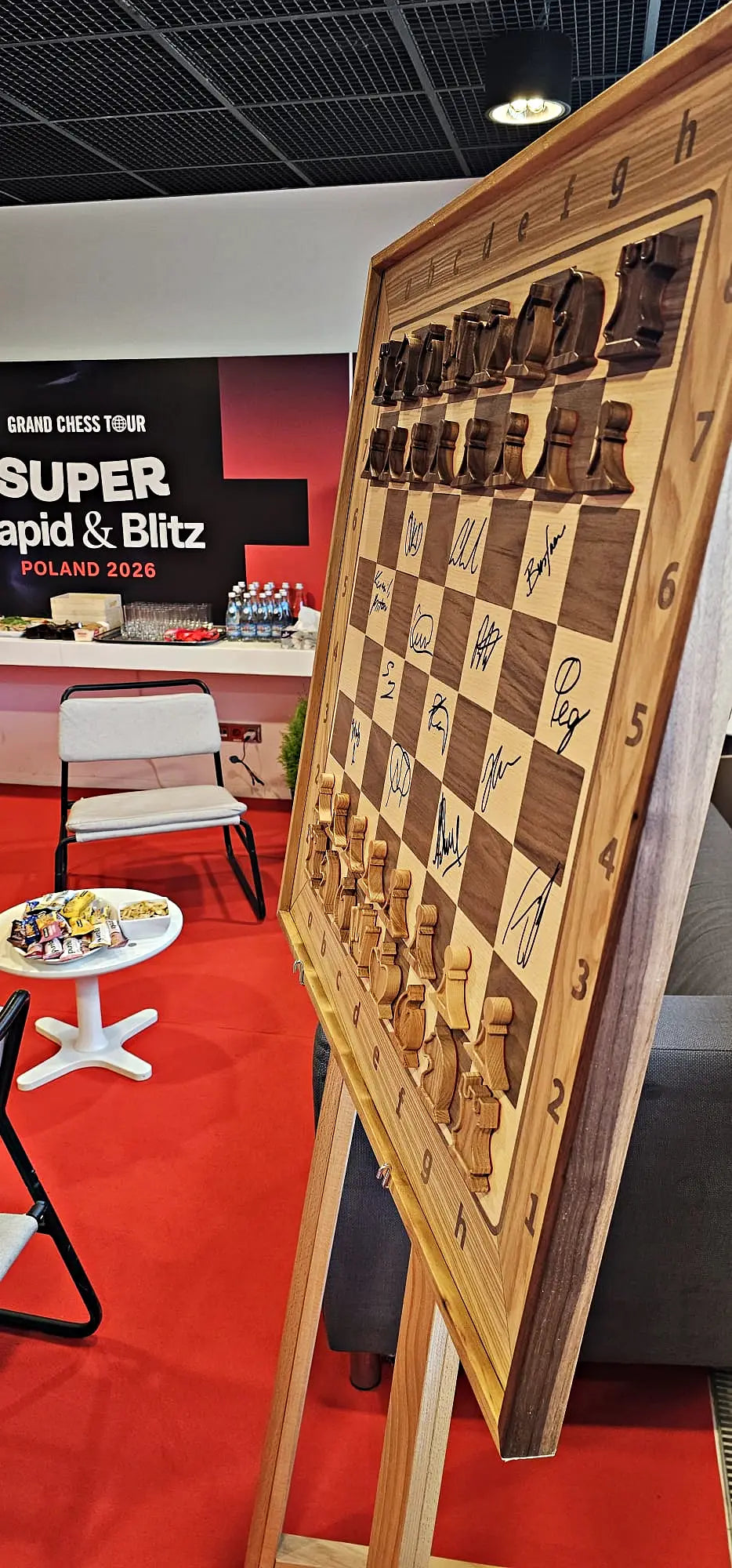 Signed wooden ChessboArt board with player autographs from Grand Chess Tour Warsaw 2026