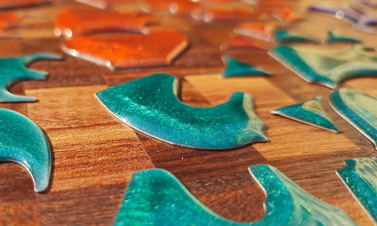 Macro shot of loose turquoise and orange epoxy resin pieces before being fitted as chess inlays