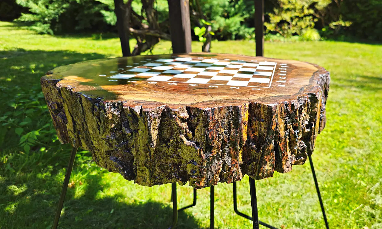 Close-up of the natural live-edge bark texture on the massive walnut wood chess table.