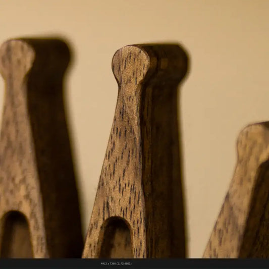 Close-up detail of a handcrafted wooden chess queen showing wood texture and fine craftsmanship, fine art photography by Monika Burszczan