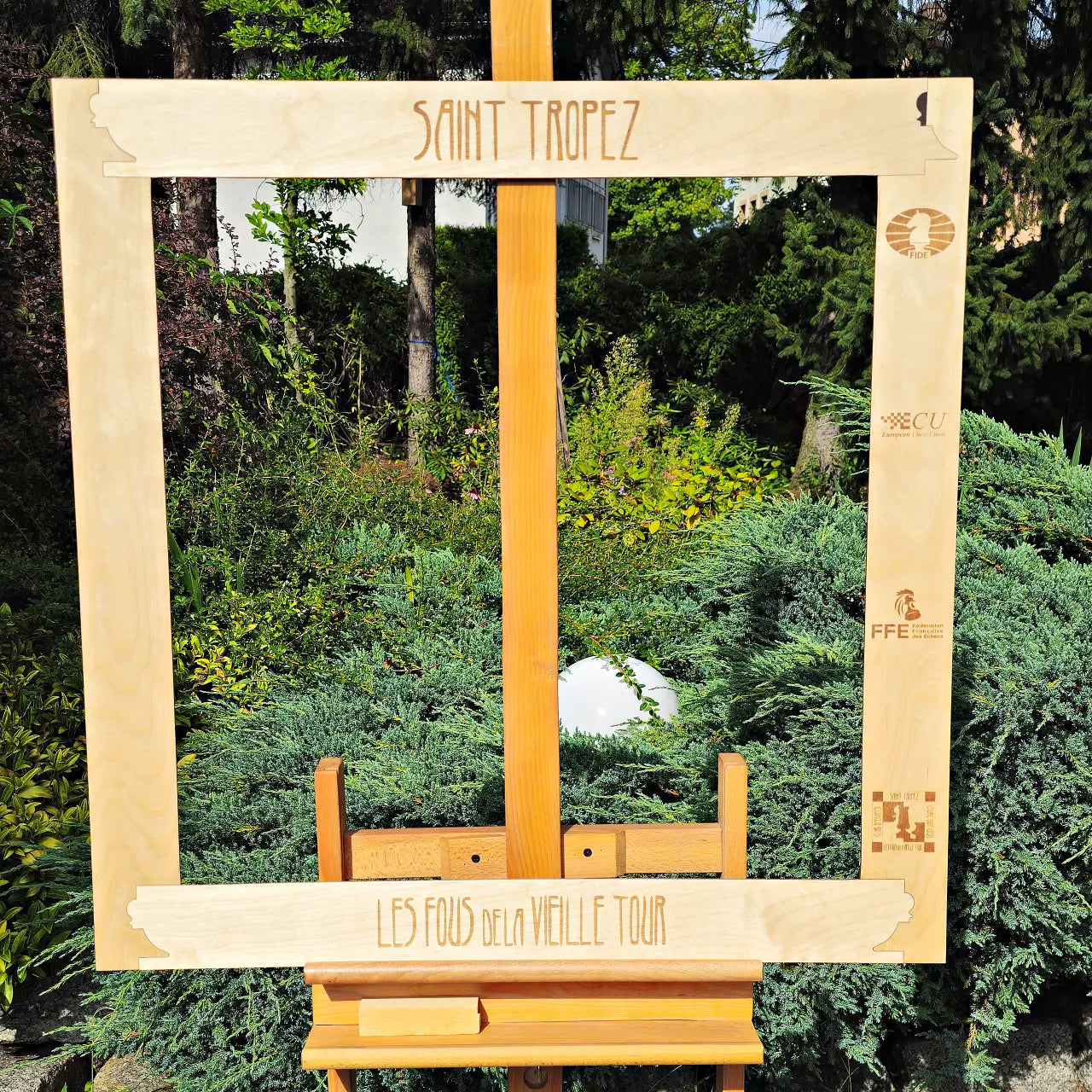 Birch side of a personalized double-sided wall chess frame engraved with a chess club name and federation logos