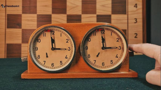 Close-up video demonstration of a vintage Hungarian MOM chess clock. The footage details the wooden casing condition, the mechanical wind-up movement, and the analog dial with a functional falling flag.