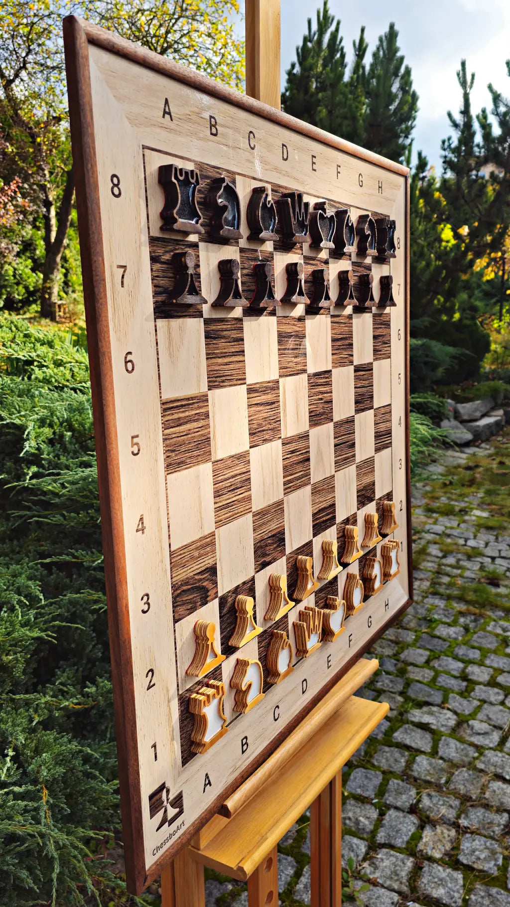 Vertical wall chess board with sapele frame and 32 magnetic plywood pieces, angled view