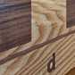 Detail of ChessboArt800 wall chess board edge in dark ash wood, showcasing precision craftsmanship and premium materials