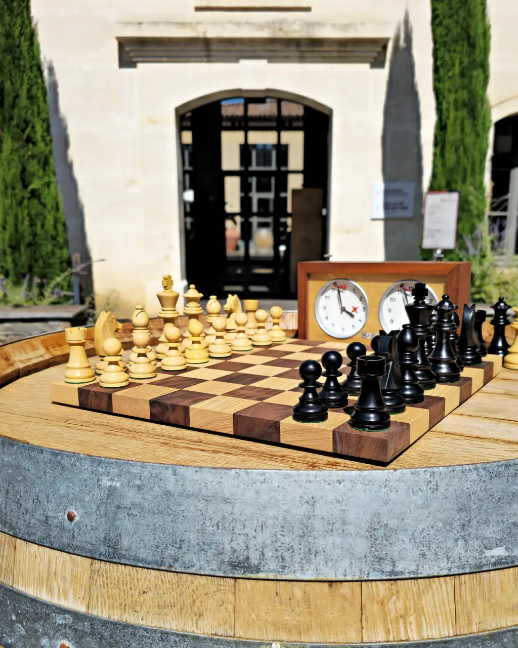 Chess set mid-game on a wine barrel outside the entrance to Le Vignoble Torpez, Saint-Tropez